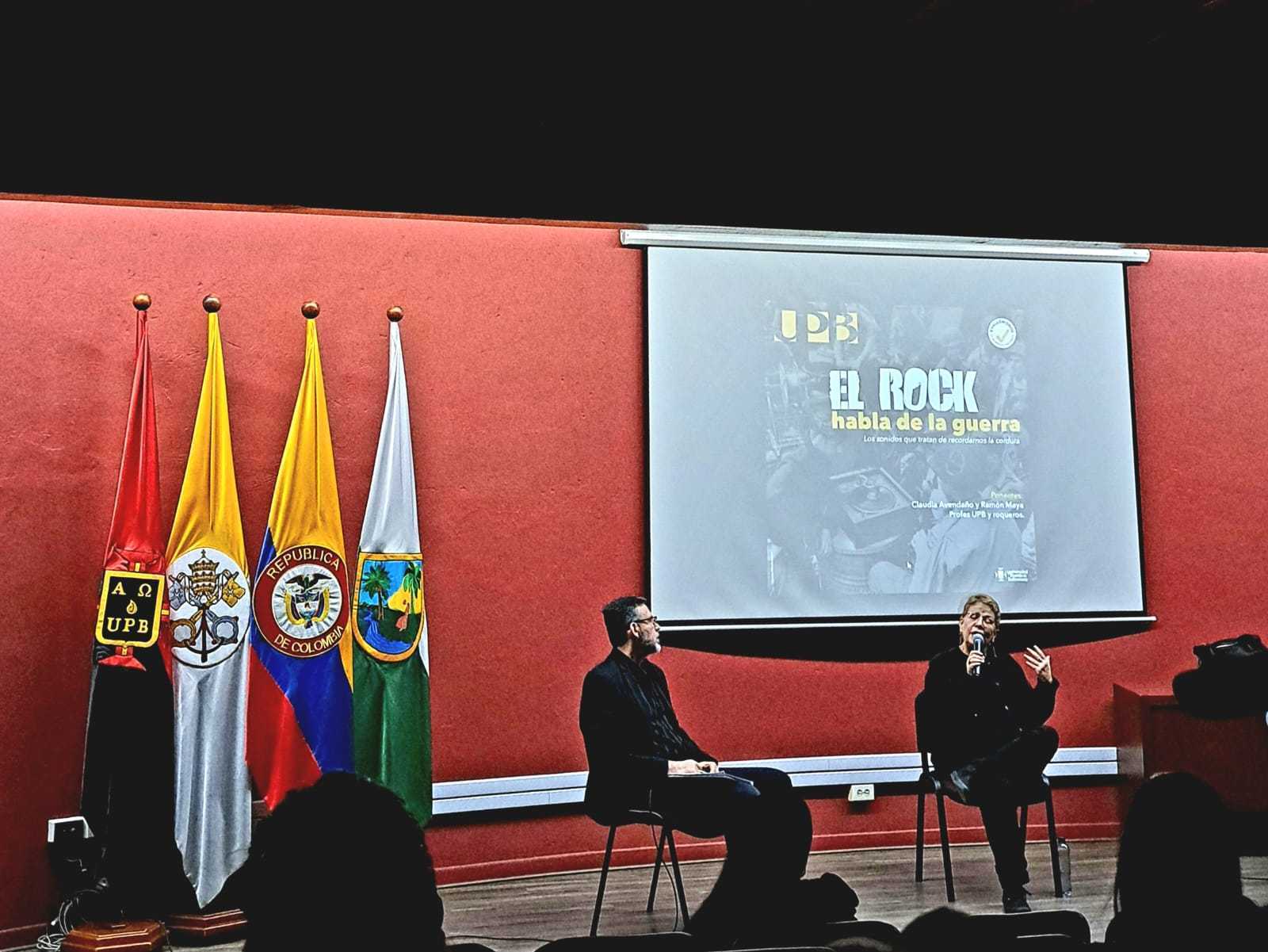 Conferencia el rock habla de la guerra a cargo de lo docentes Ramón Maya y Claudia Avendaño 