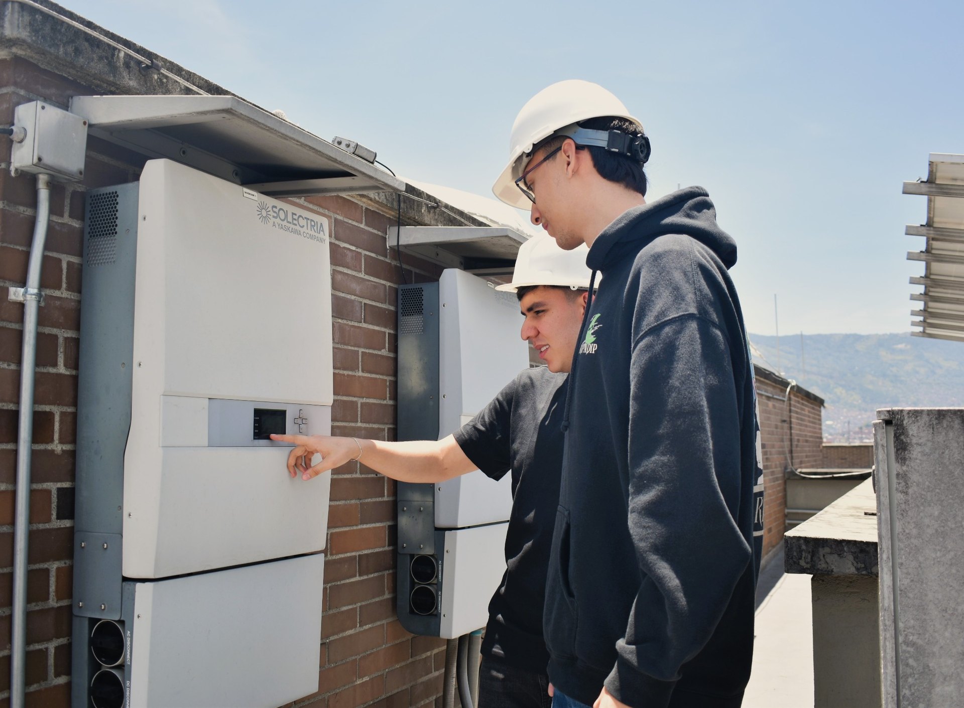 Estudiantes del pregrado de ingeniería eléctrica en las instalaciones del bloque 11 en los páneles solaresde la UPB
